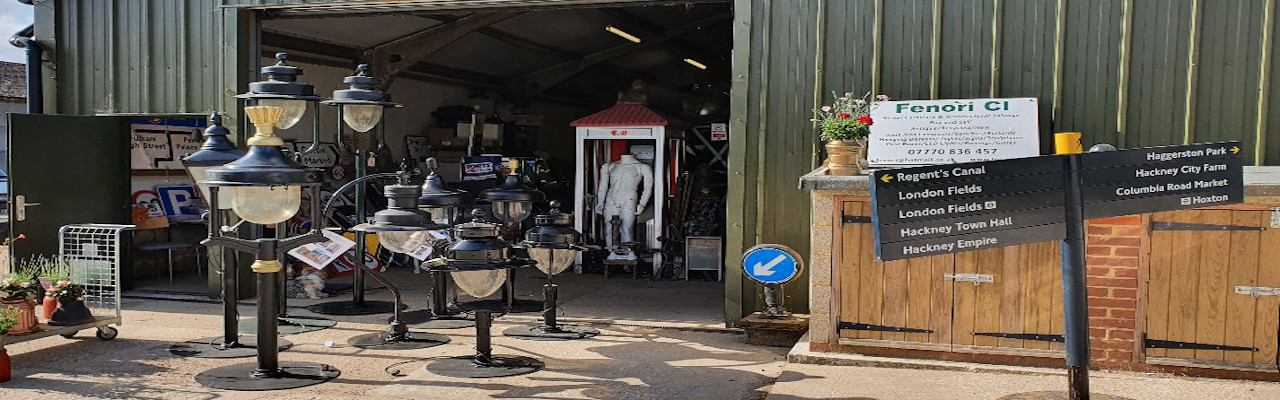 "Fenori CI heritage street furniture salvage yard with reclaimed antique lamp posts and road signage in the UK."
